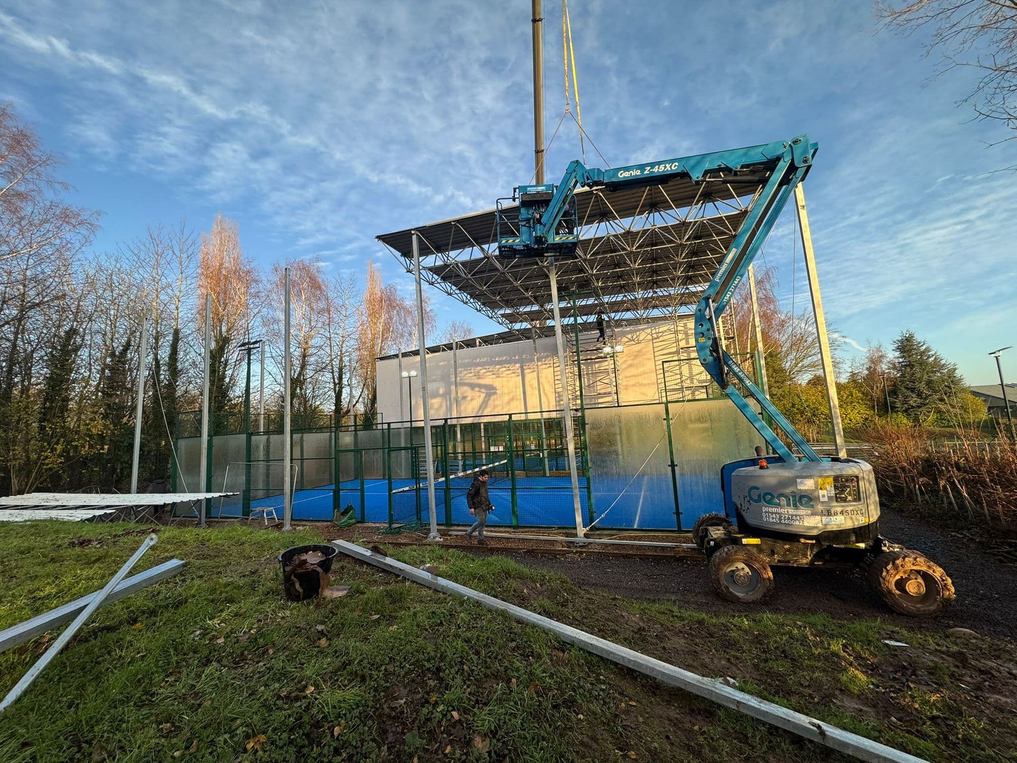 Crane working on blue roofing project