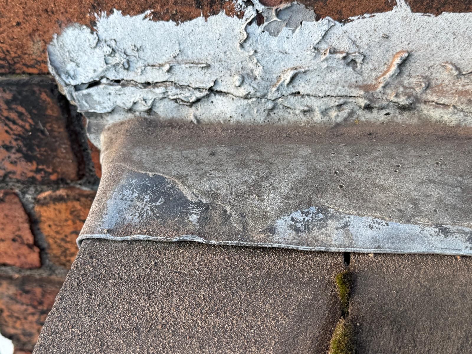Close-up: Damaged flashing vs. fresh lead — Before